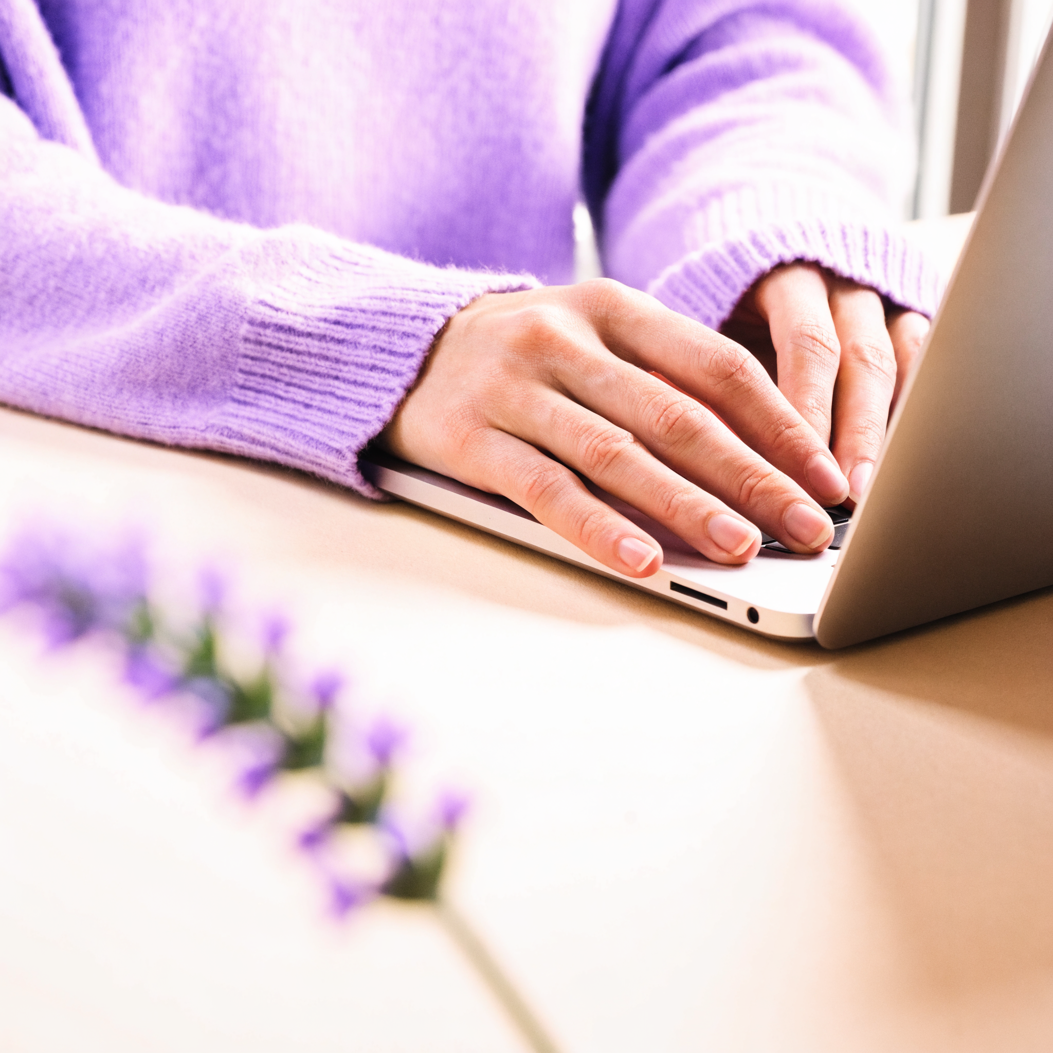 A woman looking overwhelmed at her laptop.